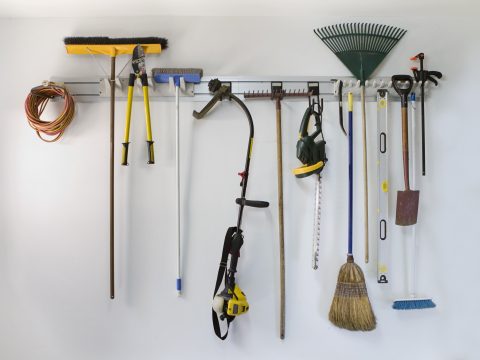 Neat garage tools hanging on a storage rack